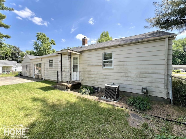 435 Brandon St, Owosso, MI 48867 - back of property with a yard and a chimney