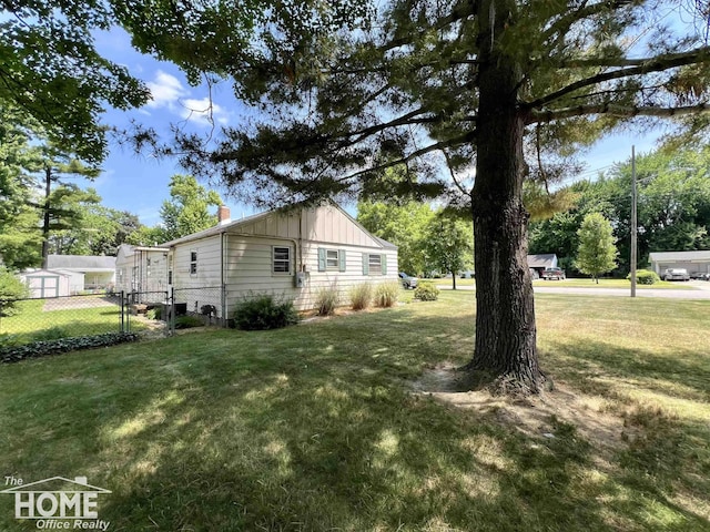 435 Brandon St, Owosso, MI 48867 - view of property exterior featuring board and batten siding and a chimney