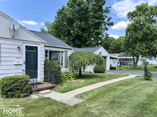 435 Brandon St, Owosso, MI 48867 - view of front of property featuring a front lawn, a shingled roof, and board and batten siding