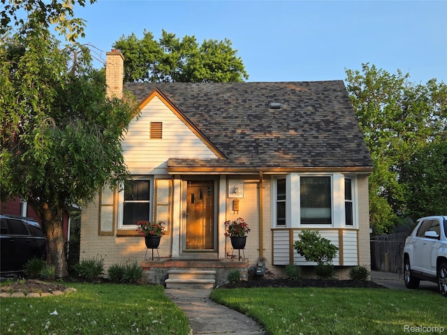 11509 Balfour, Detroit, MI 48224 - view of front of property with a front yard, a chimney, brick siding, and roof with shingles