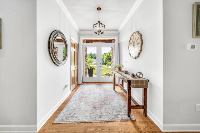 6143 Pheasant Ct, Berrien Springs, MI 49103 - foyer entrance with french doors, ornamental molding, wood finished floors, and a chandelier