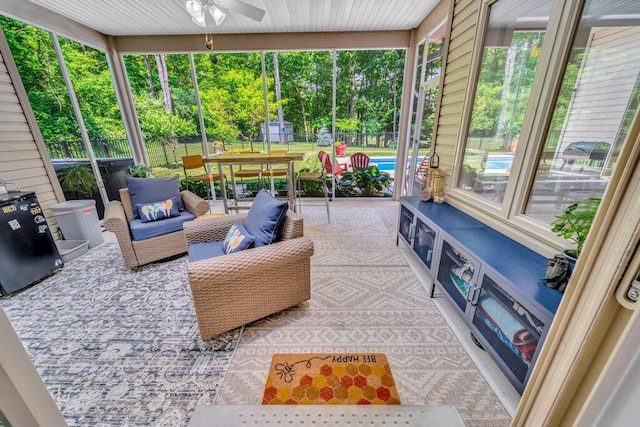 6143 Pheasant Ct, Berrien Springs, MI 49103 - sunroom / solarium featuring a ceiling fan, view of scattered trees, and an outdoor hangout area