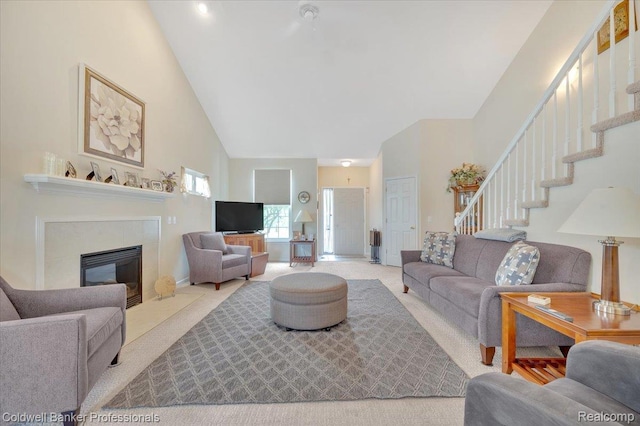 6087 Davison Rd, Byron, MI 48509 - living room with high vaulted ceiling, carpet floors, stairway, and a fireplace with flush hearth
