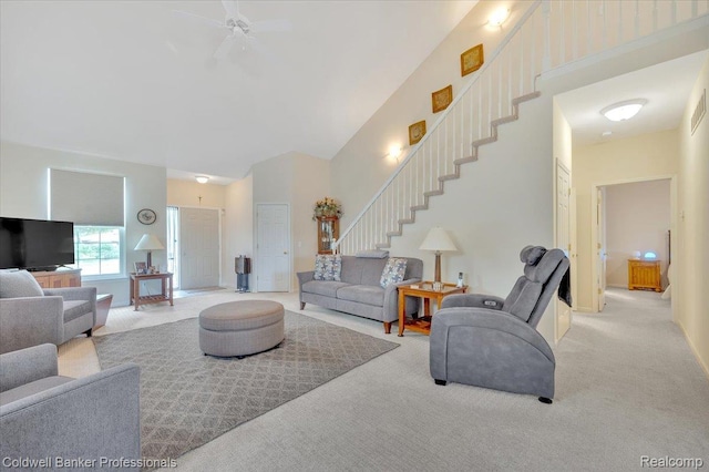 6087 Davison Rd, Byron, MI 48509 - living area featuring stairway, a ceiling fan, light colored carpet, and a towering ceiling