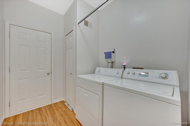 6087 Davison Rd, Byron, MI 48509 - laundry room with separate washer and dryer and light wood-style flooring