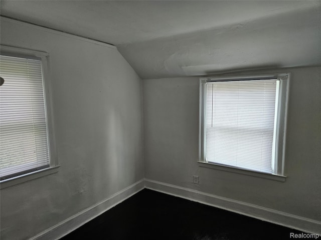 4294 W Buena Vista St, Detroit, MI 48238 - empty room featuring vaulted ceiling and dark wood-style floors