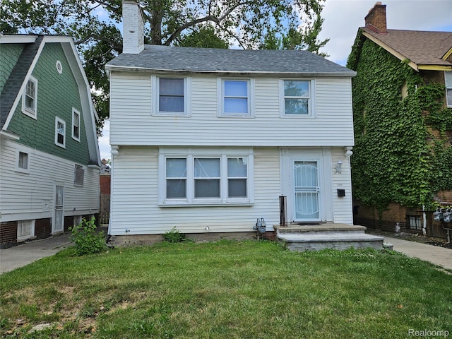 4294 W Buena Vista St, Detroit, MI 48238 - colonial inspired home with a front yard and a chimney