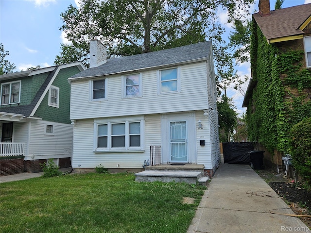 4294 W Buena Vista St, Detroit, MI 48238 - view of front facade with a chimney and concrete driveway
