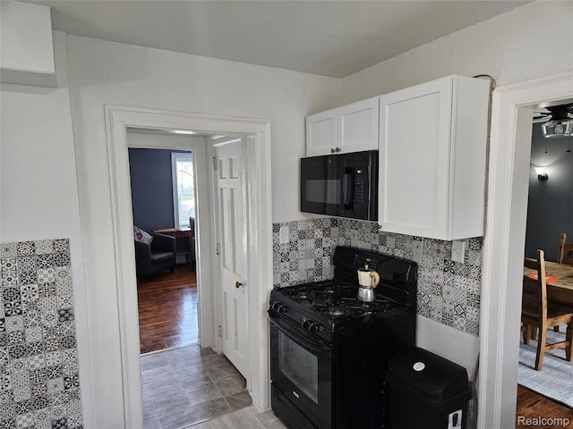 4294 W Buena Vista St, Detroit, MI 48238 - kitchen with black appliances, white cabinetry, and tasteful backsplash