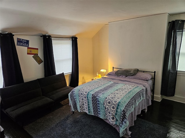 4294 W Buena Vista St, Detroit, MI 48238 - bedroom with multiple windows, vaulted ceiling, and wood finished floors