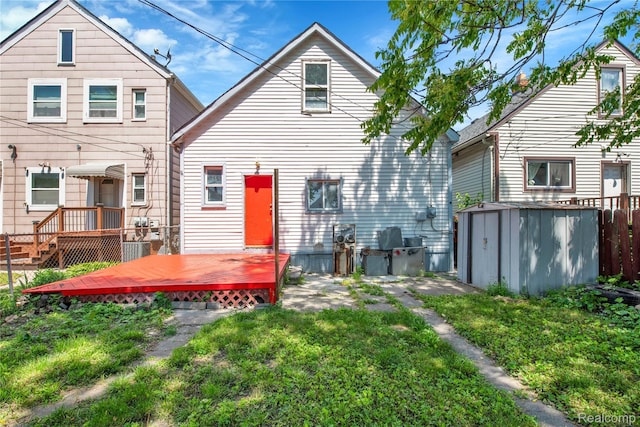 3368 Evaline St, Hamtramck, MI 48212 - back of property with a storage shed, a deck, and a lawn