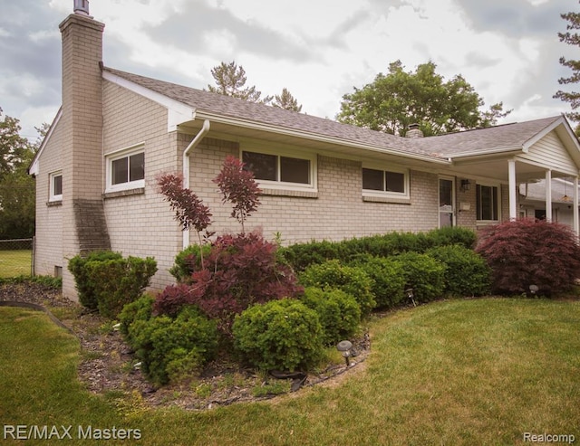 5820 Houghten Dr, Troy, MI 48098 - view of side of property with a chimney and brick siding