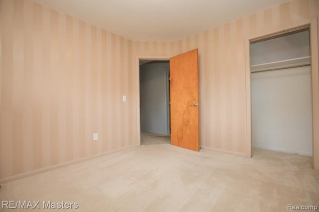 5820 Houghten Dr, Troy, MI 48098 - unfurnished bedroom with wallpapered walls, carpet flooring, and a closet