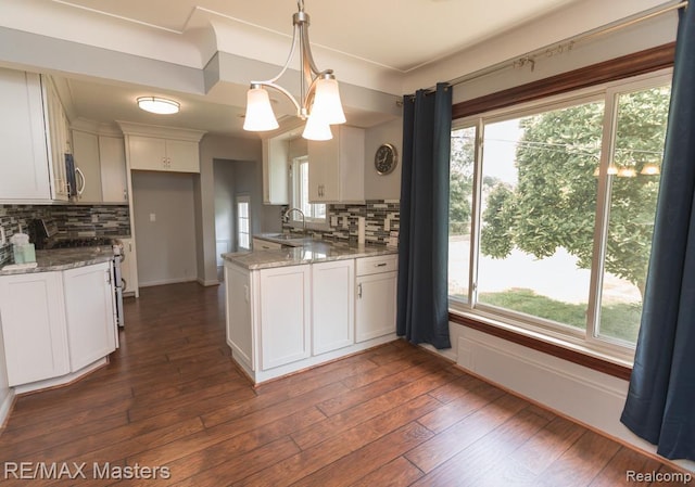 5820 Houghten Dr, Troy, MI 48098 - kitchen featuring tasteful backsplash, white cabinets, light stone counters, and a peninsula