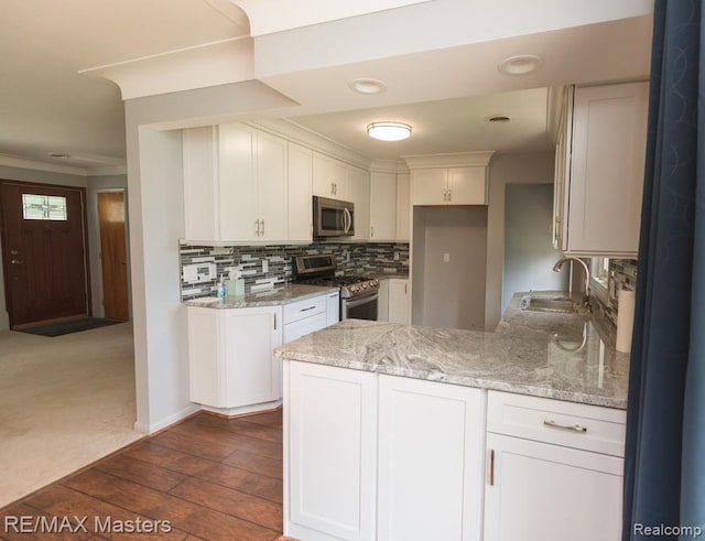 5820 Houghten Dr, Troy, MI 48098 - kitchen featuring appliances with stainless steel finishes, a peninsula, light stone counters, white cabinets, and recessed lighting