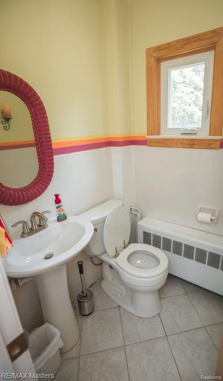 5820 Houghten Dr, Troy, MI 48098 - bathroom with radiator heating unit and tile patterned floors