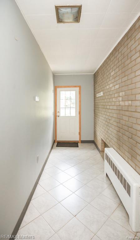 5820 Houghten Dr, Troy, MI 48098 - doorway to outside with radiator and brick wall