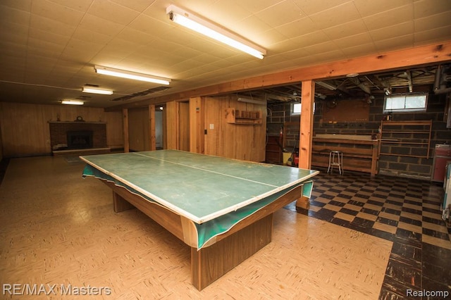 5820 Houghten Dr, Troy, MI 48098 - recreation room featuring tile patterned floors, wooden walls, and a fireplace