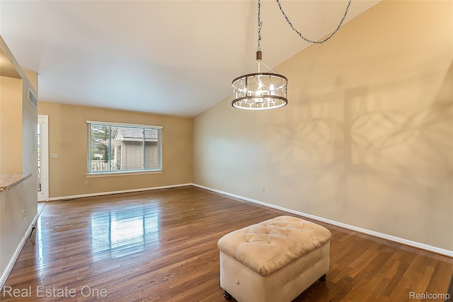 62622 Raleigh Ct Unit 4, South Lyon, MI 48178 - empty room featuring a chandelier, dark wood-style floors, and vaulted ceiling