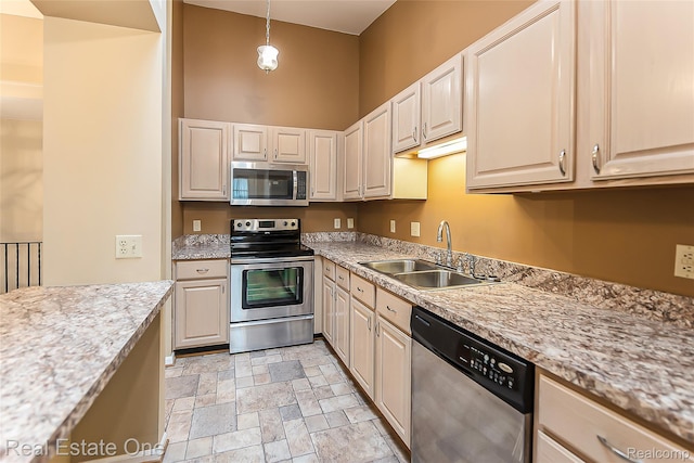 62622 Raleigh Ct Unit 4, South Lyon, MI 48178 - kitchen featuring stainless steel appliances, stone finish floors, and hanging light fixtures