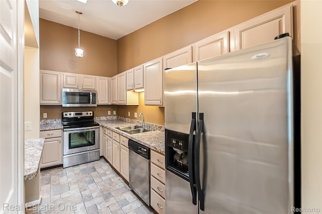 62622 Raleigh Ct Unit 4, South Lyon, MI 48178 - kitchen with appliances with stainless steel finishes, a high ceiling, decorative light fixtures, stone finish floors, and light stone counters