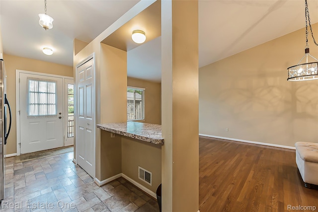 62622 Raleigh Ct Unit 4, South Lyon, MI 48178 - foyer featuring baseboards and stone finish floors