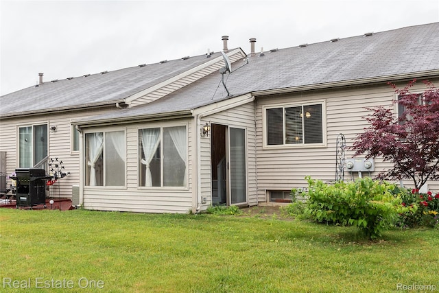 62622 Raleigh Ct Unit 4, South Lyon, MI 48178 - rear view of house featuring a lawn