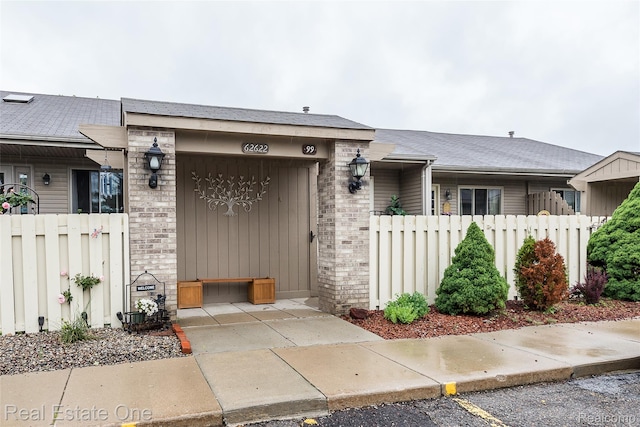 62622 Raleigh Ct Unit 4, South Lyon, MI 48178 - view of front facade with a garage and brick siding