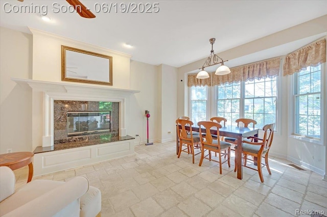 43443 Mclean Ct, Novi, MI 48375 - dining room featuring stone tile flooring and a high end fireplace