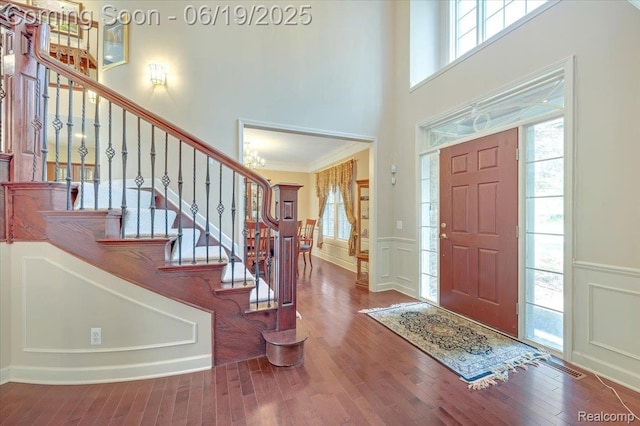 43443 Mclean Ct, Novi, MI 48375 - entryway featuring a decorative wall, wood finished floors, stairs, wainscoting, and crown molding