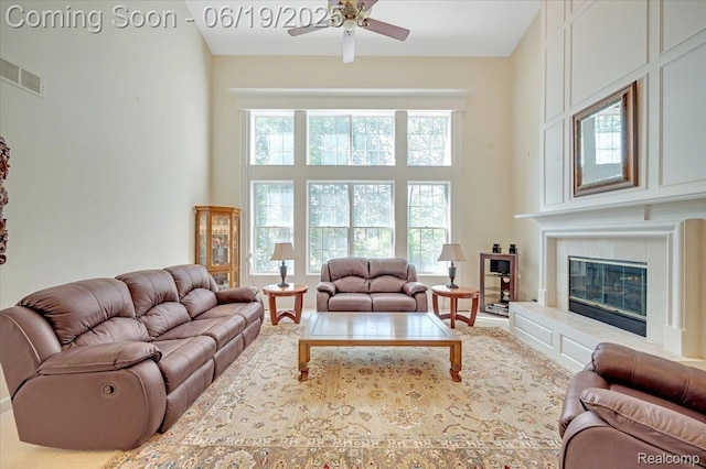 43443 Mclean Ct, Novi, MI 48375 - living room with ceiling fan, a towering ceiling, and a fireplace
