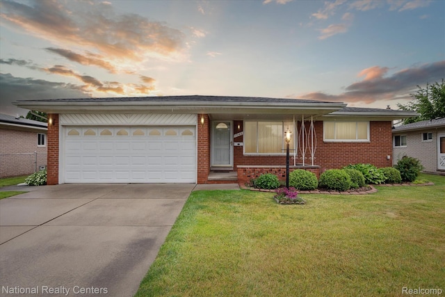 13142 Boca Grande Dr, Sterling Heights, MI 48312 - view of front facade with concrete driveway, brick siding, a front yard, and an attached garage