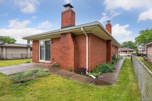 13142 Boca Grande Dr, Sterling Heights, MI 48312 - back of house with a chimney, brick siding, and a patio area
