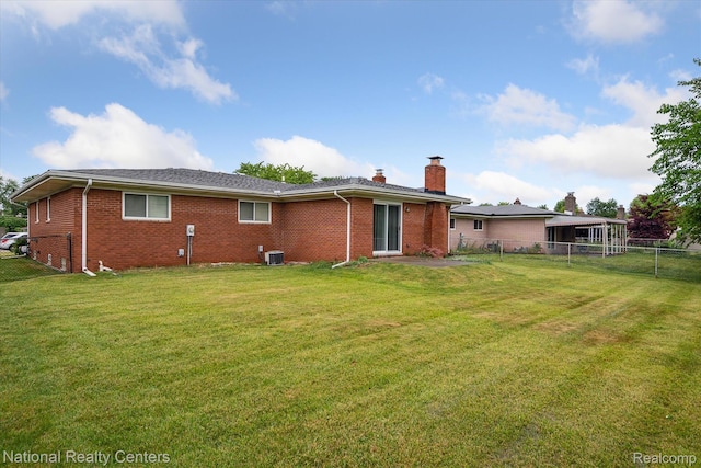 13142 Boca Grande Dr, Sterling Heights, MI 48312 - back of property featuring a chimney, brick siding, and a fenced backyard