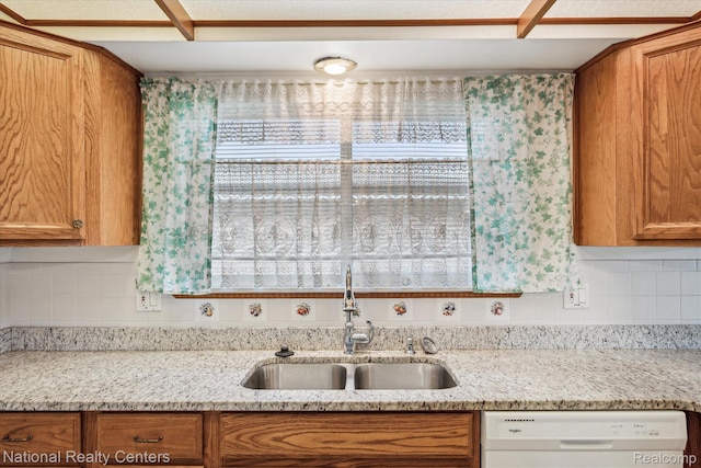 13142 Boca Grande Dr, Sterling Heights, MI 48312 - kitchen with white dishwasher, brown cabinets, decorative backsplash, and light stone counters