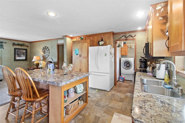 501 Kinloch, Temperance, MI 48182 - kitchen with freestanding refrigerator, washer / clothes dryer, crown molding, an island with sink, and a kitchen bar
