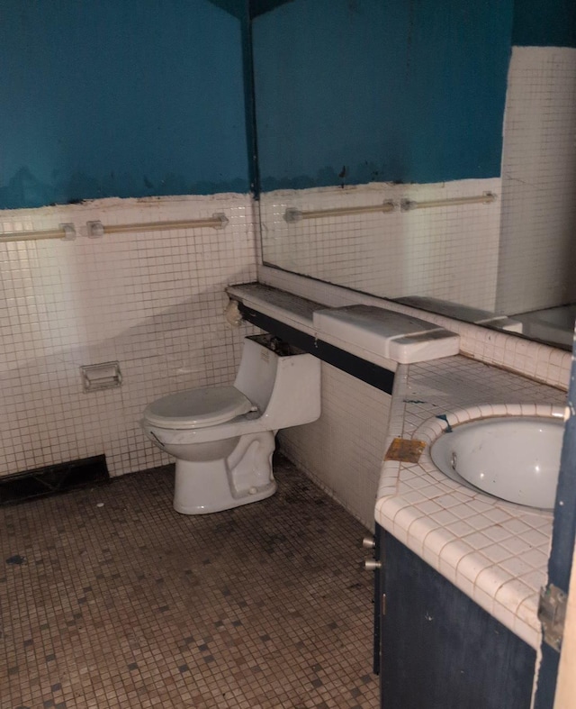 13235 Waterstradt Rd, Marcellus, MI 49067 - half bath featuring tile walls, vanity, and wainscoting