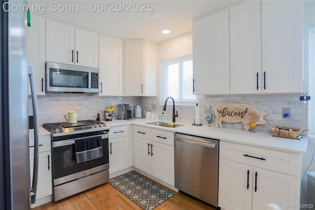 14839 Chippewa Dr, Warren, MI 48088 - kitchen with appliances with stainless steel finishes, light countertops, white cabinetry, tasteful backsplash, and recessed lighting
