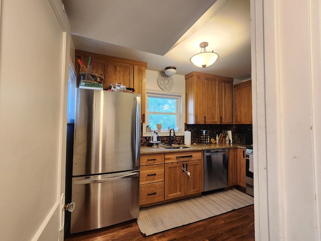 1908 Lakeway Ave, Kalamazoo, MI 49001 - kitchen with appliances with stainless steel finishes, brown cabinets, and dark wood-style floors