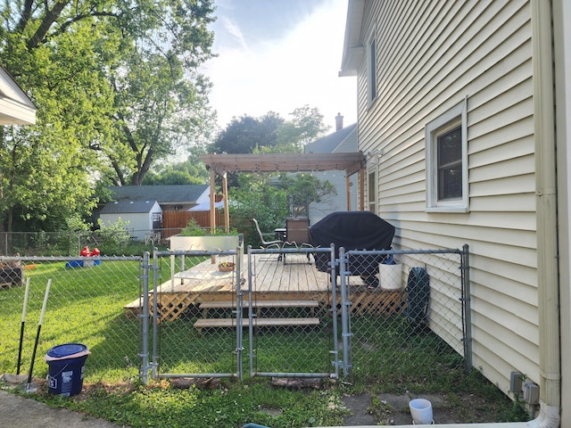 1908 Lakeway Ave, Kalamazoo, MI 49001 - fenced backyard with a wooden deck, a gate, and a pergola