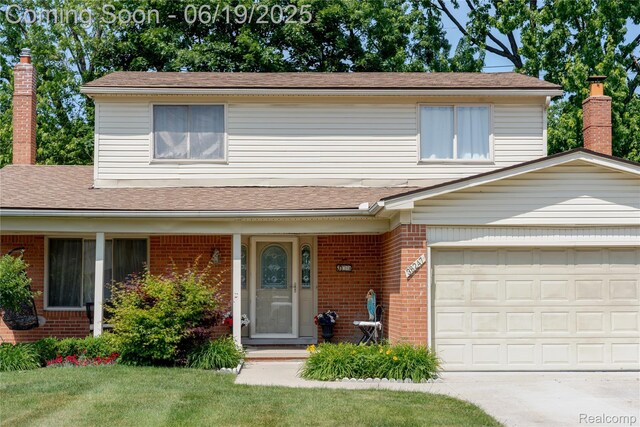 38247 Forsdale Dr, Sterling Heights, MI 48310 - traditional-style house with brick siding, driveway, roof with shingles, a chimney, and a front yard