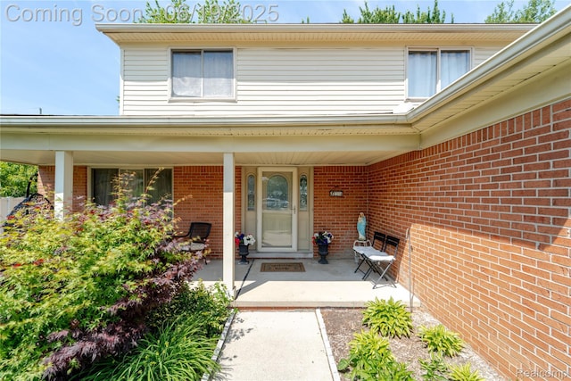 38247 Forsdale Dr, Sterling Heights, MI 48310 - view of exterior entry featuring brick siding and a porch