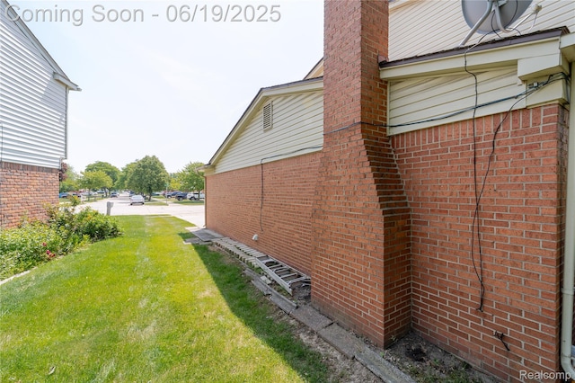 38247 Forsdale Dr, Sterling Heights, MI 48310 - view of home's exterior with a lawn, brick siding, and a chimney