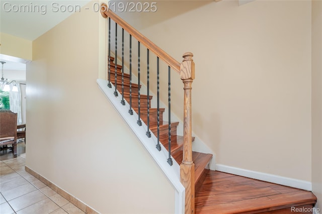 38247 Forsdale Dr, Sterling Heights, MI 48310 - staircase with tile patterned flooring and a chandelier