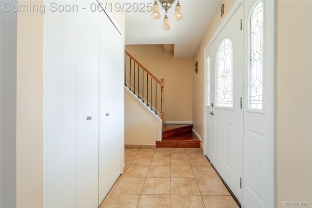 38247 Forsdale Dr, Sterling Heights, MI 48310 - foyer entrance with a chandelier, stairway, and light tile patterned flooring