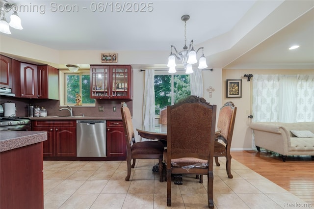 38247 Forsdale Dr, Sterling Heights, MI 48310 - kitchen with stainless steel appliances, reddish brown cabinets, a chandelier, healthy amount of natural light, and recessed lighting
