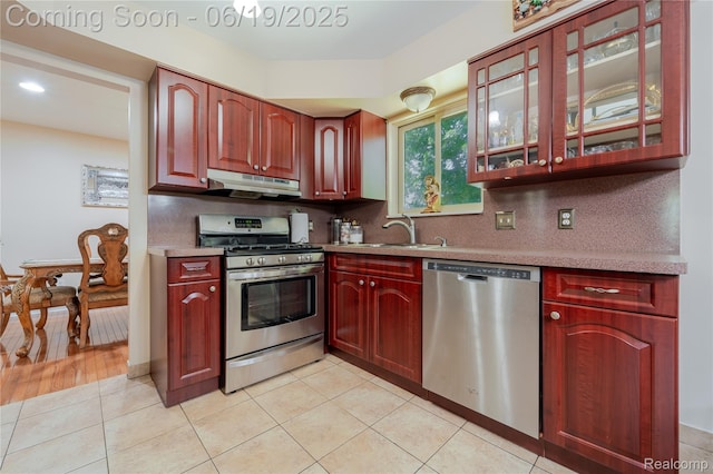 38247 Forsdale Dr, Sterling Heights, MI 48310 - kitchen featuring appliances with stainless steel finishes, under cabinet range hood, reddish brown cabinets, and recessed lighting