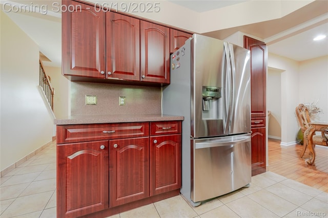 38247 Forsdale Dr, Sterling Heights, MI 48310 - kitchen featuring stainless steel refrigerator with ice dispenser, light tile patterned floors, reddish brown cabinets, light countertops, and decorative backsplash