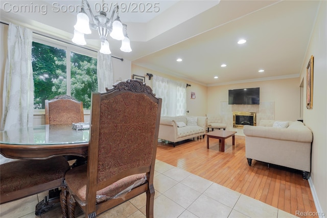 38247 Forsdale Dr, Sterling Heights, MI 48310 - tiled dining space featuring a chandelier, a tile fireplace, crown molding, and recessed lighting