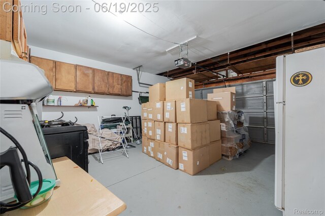 38247 Forsdale Dr, Sterling Heights, MI 48310 - garage with freestanding refrigerator and a garage door opener